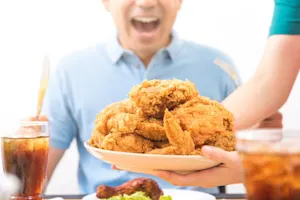 What's the name of the winner of the chicken-eating contest? image