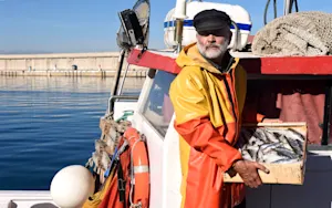 Where do fishermen look to hire more crew? image