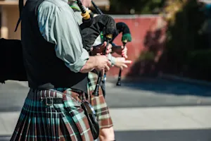 Why do bagpipe players walk when they play? image